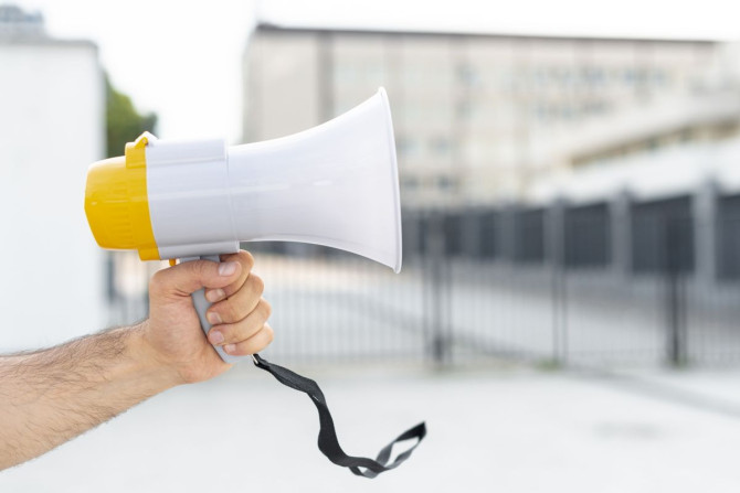 close-up-protester-holding-megaphone.jpg