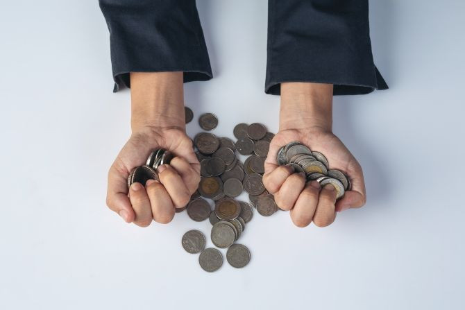 finance-accounting-concept-business-woman-holding-coin-desk.jpg