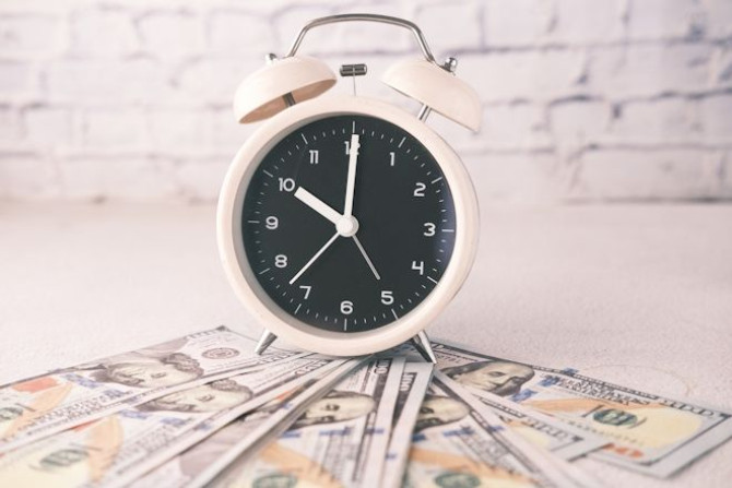 close-up-dollar-cash-old-alarm-clock-table.jpg