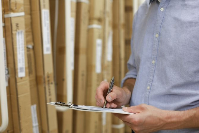 young-man-shopping-working-hardware-warehouse-standing-checking-supplies-his-tablet.jpg